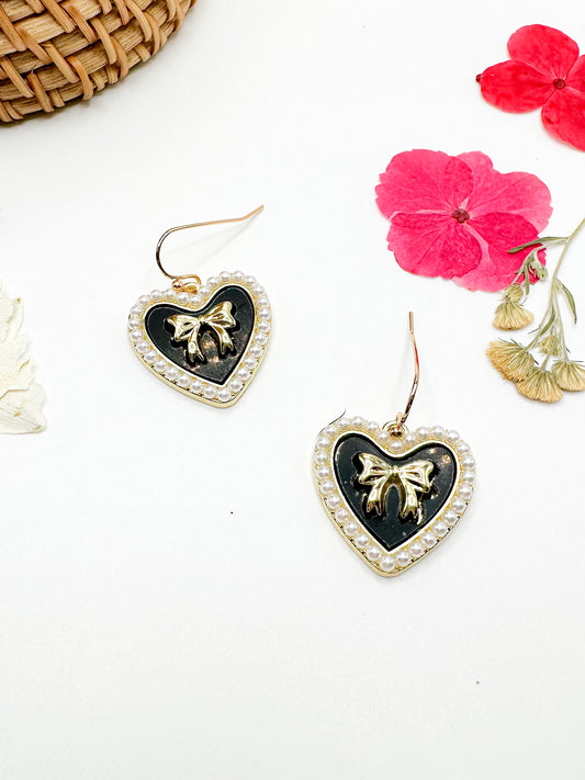 Gold heart earrings with black enamel
