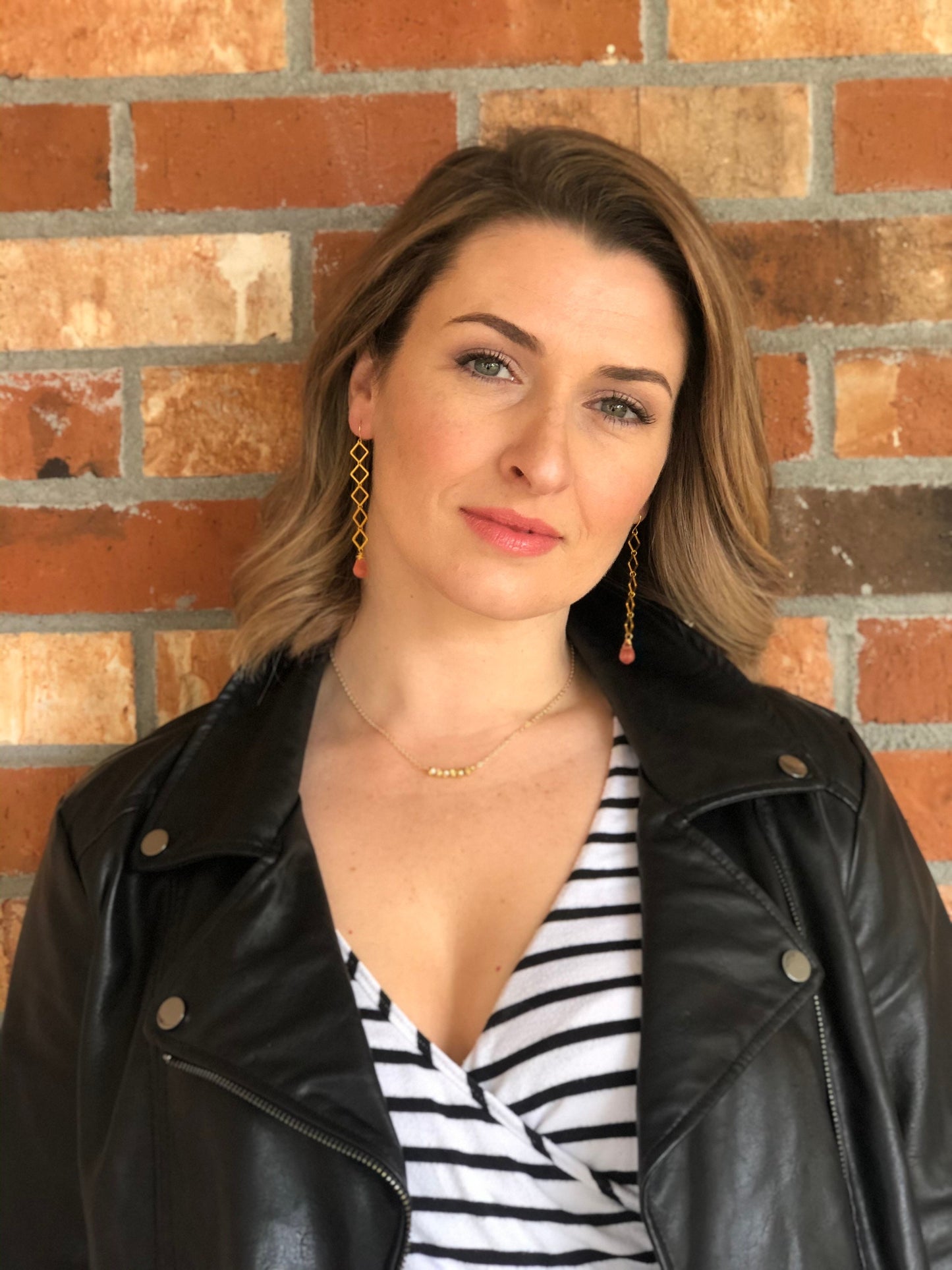 Geometric earrings dangle with cherry quartz teardrop