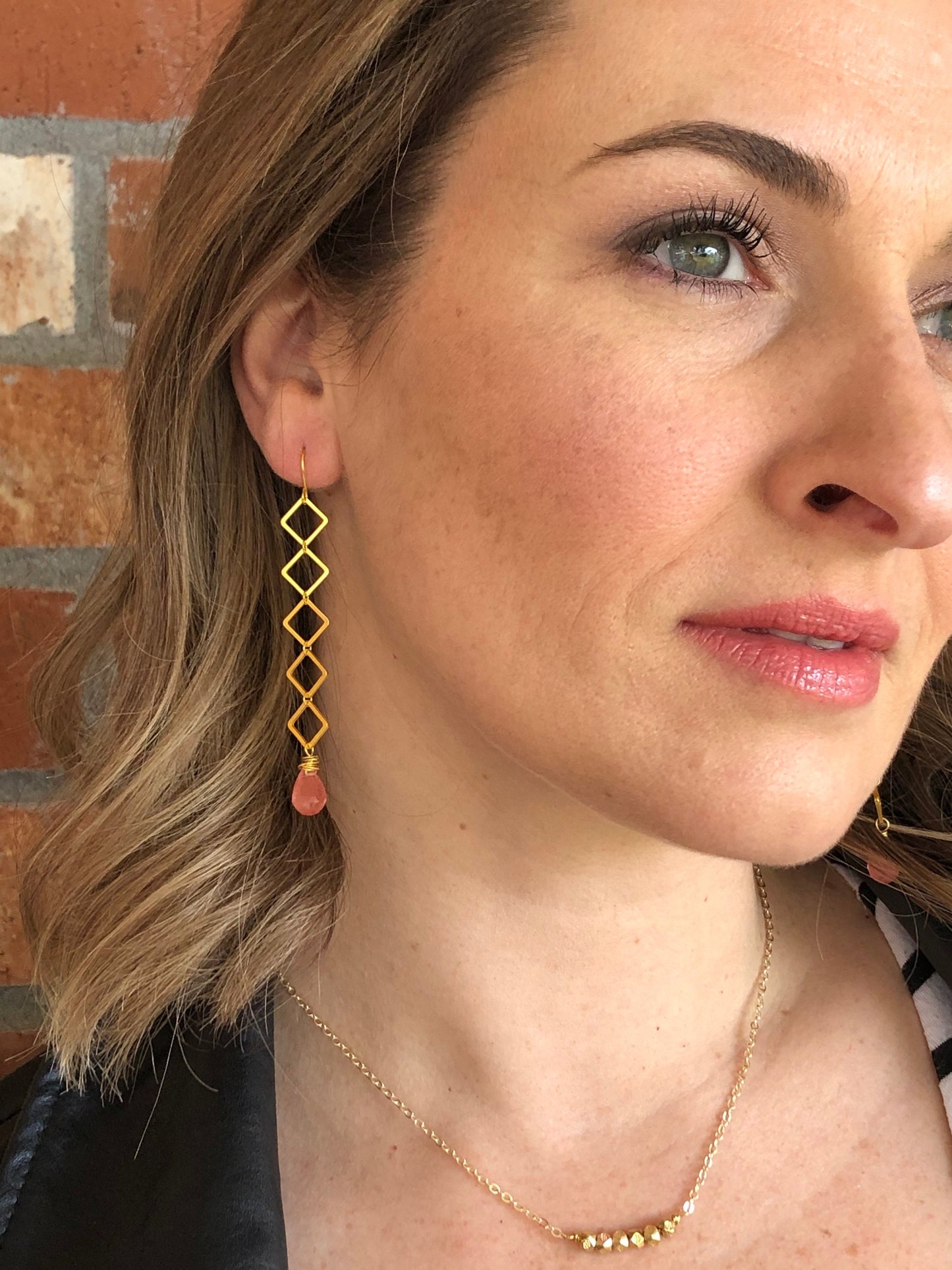 Geometric earrings dangle with cherry quartz teardrop