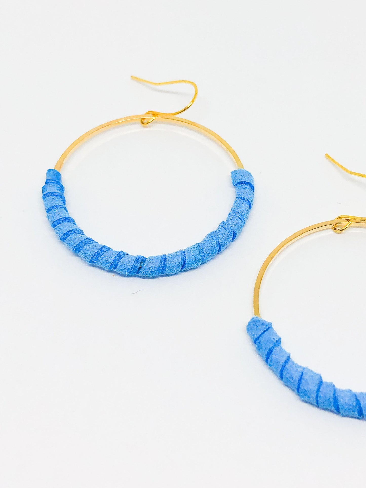 Hoop earrings wrapped in blue faux suede