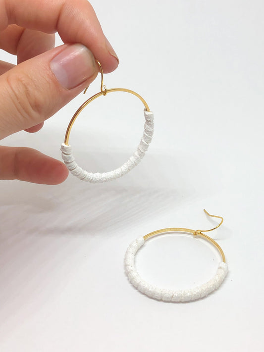 Gold hoop earrings with white faux suede