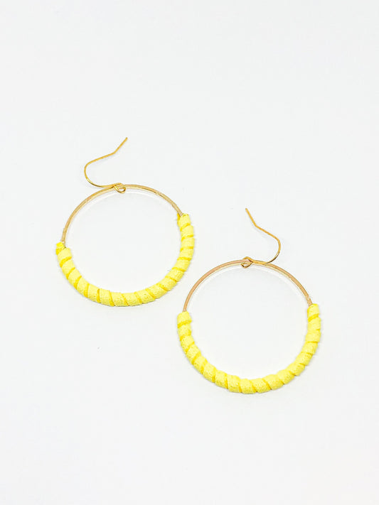 Gold hoop earrings with yellow faux suede
