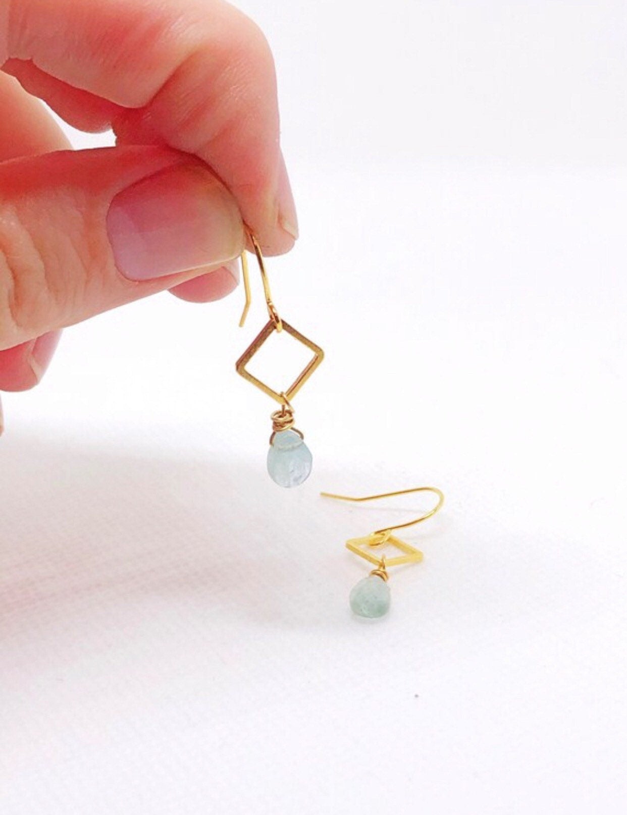 Blue aquamarine gemstone earrings with gold diamond