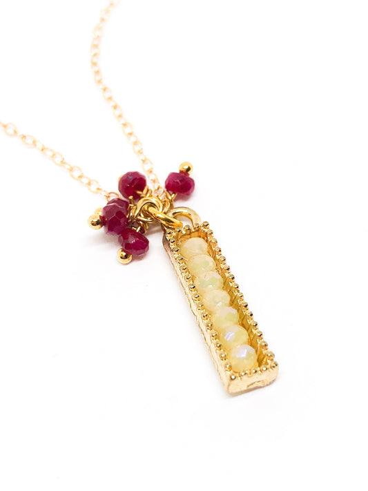 Ruby gemstone charm necklace in gold