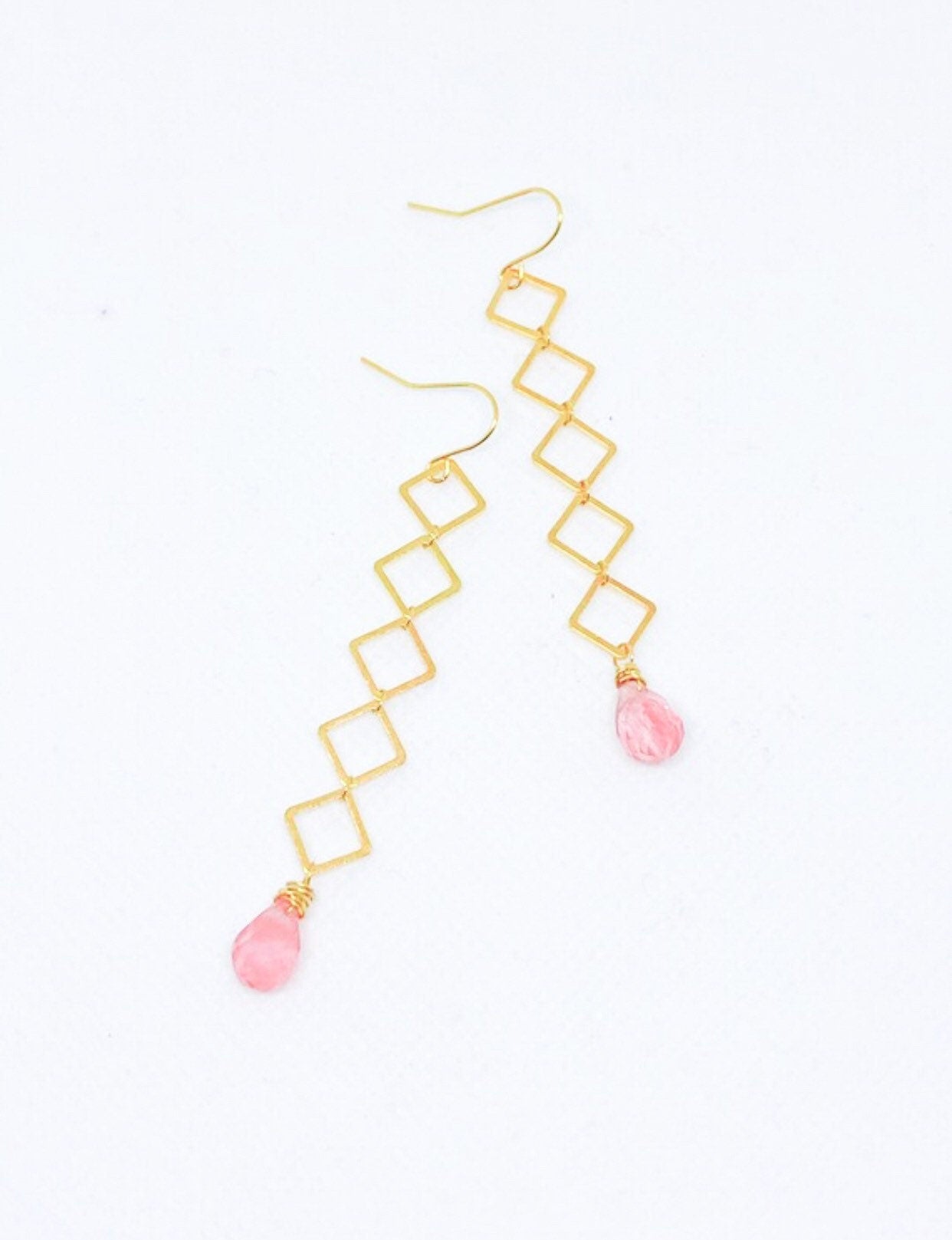 Geometric earrings dangle with cherry quartz teardrop