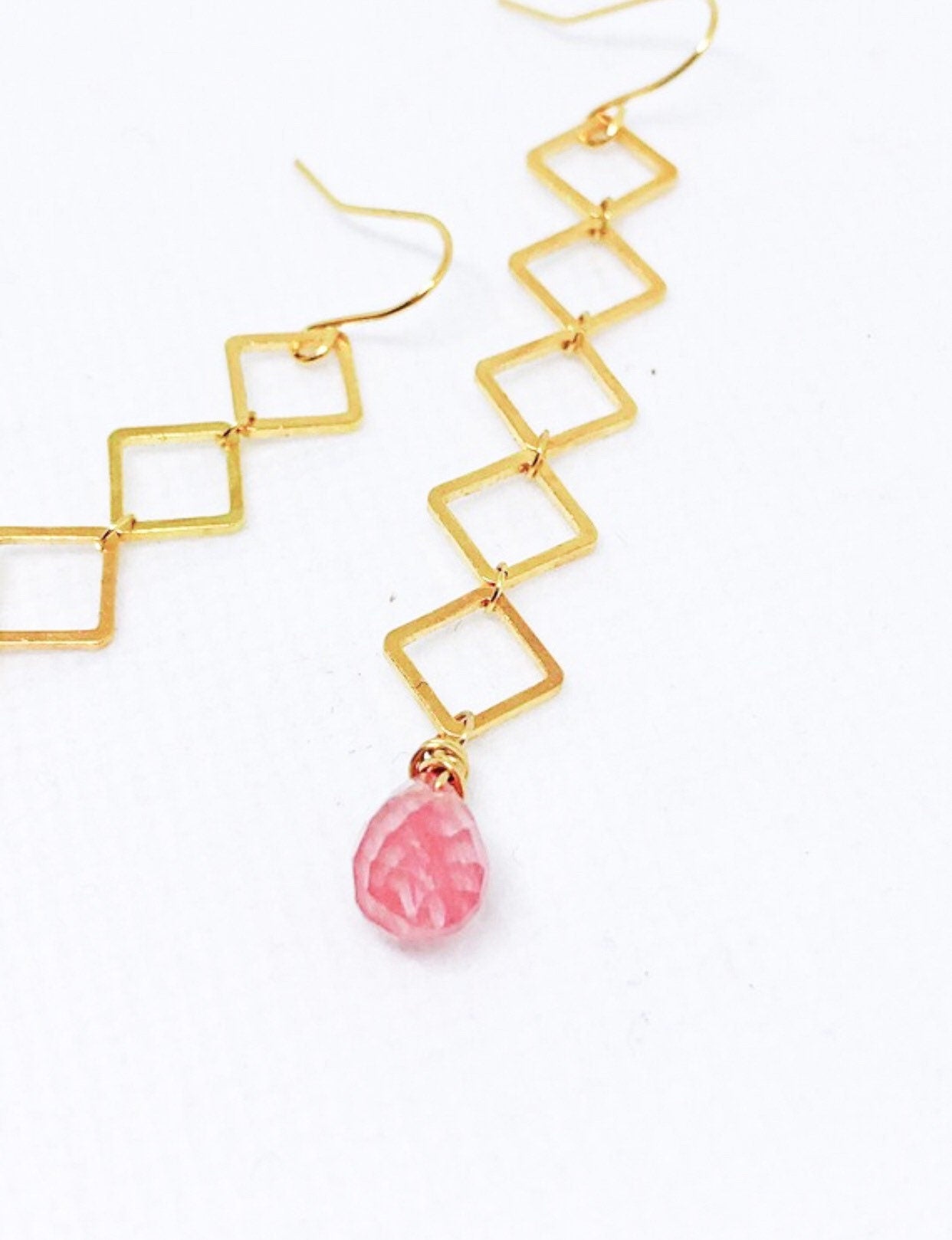 Geometric earrings dangle with cherry quartz teardrop
