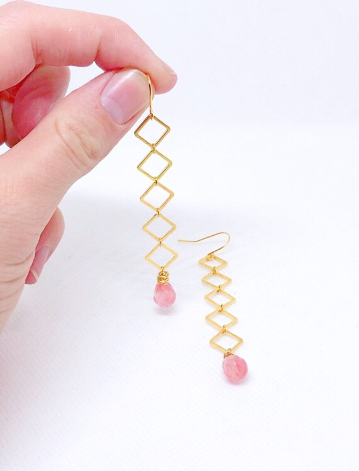 Geometric earrings dangle with cherry quartz teardrop